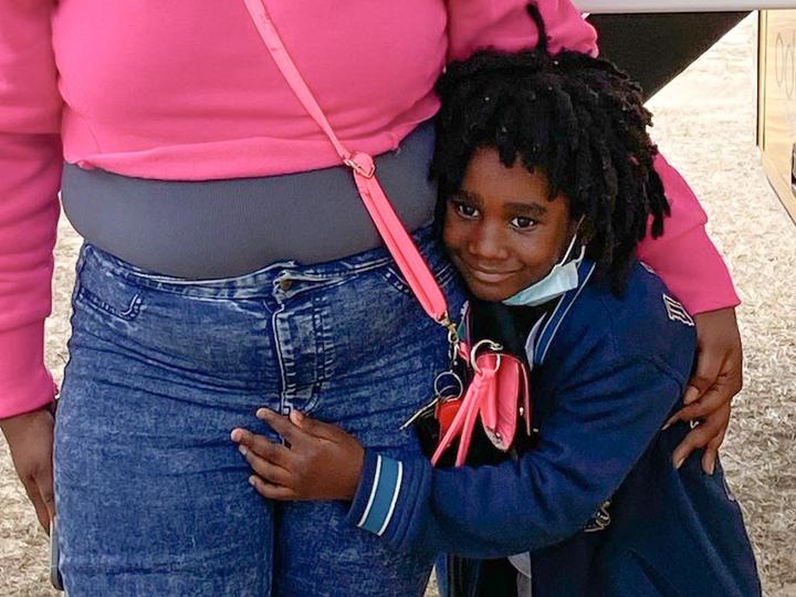 Child hugging an adult