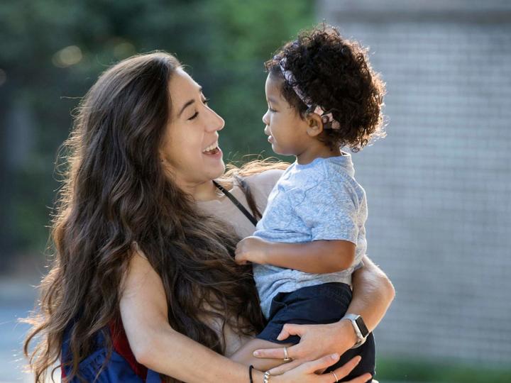 adult woman holding a toddler