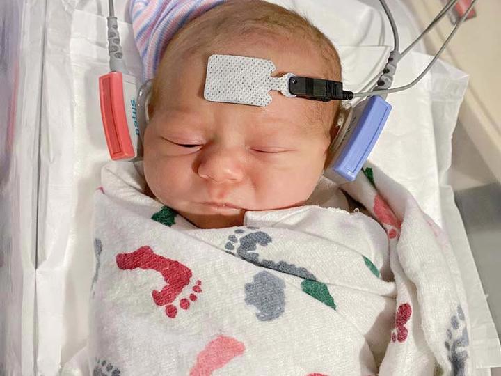 baby with hearing screening devices