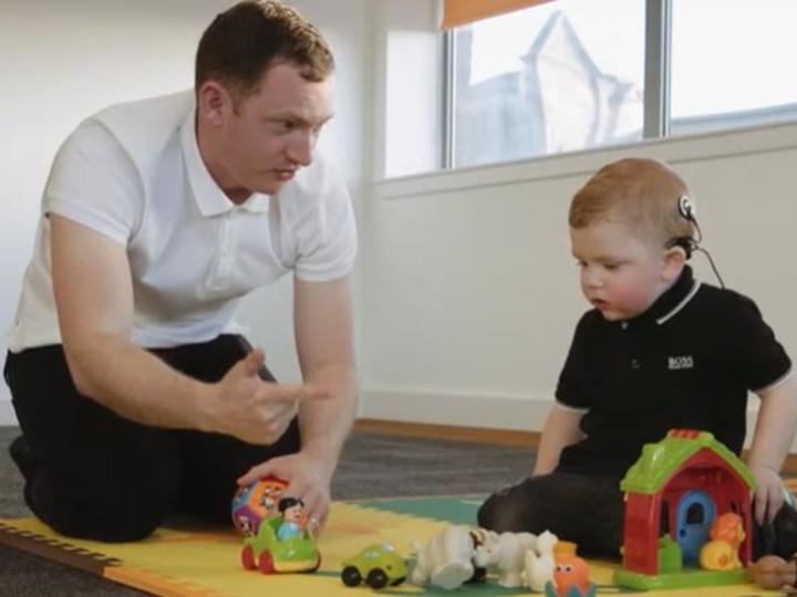 Father signing to young DHH son