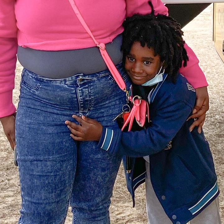 Child hugging an adult