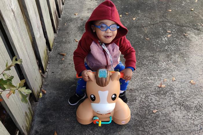 toddler riding a toy